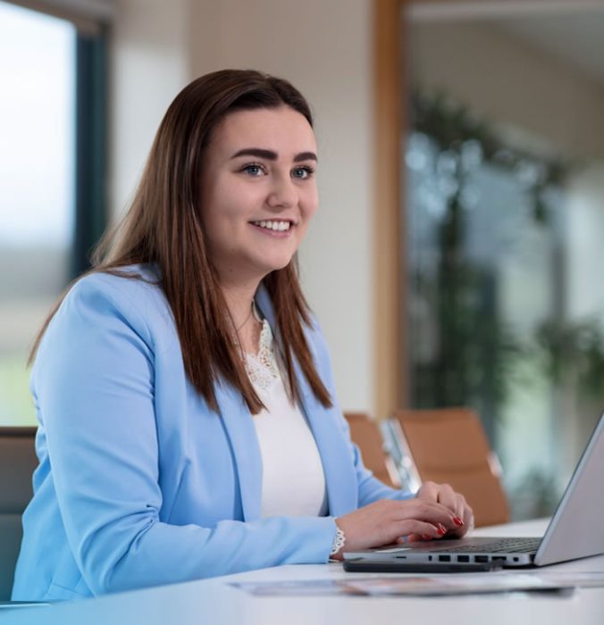 An ABP office worker sitting at her laptop