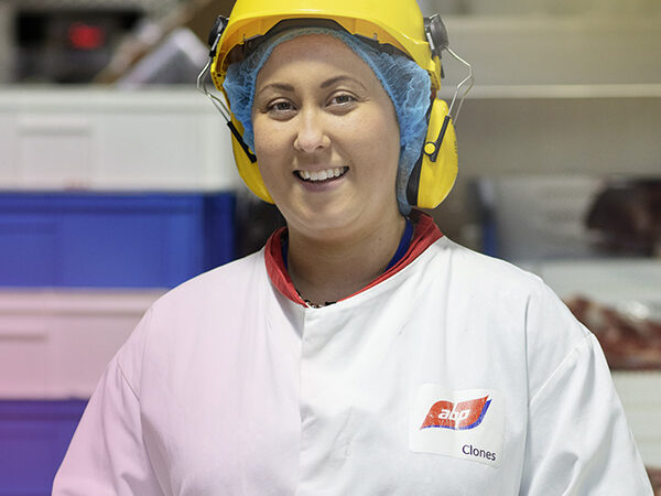 An ABP worker in white coat and yellow safety hat