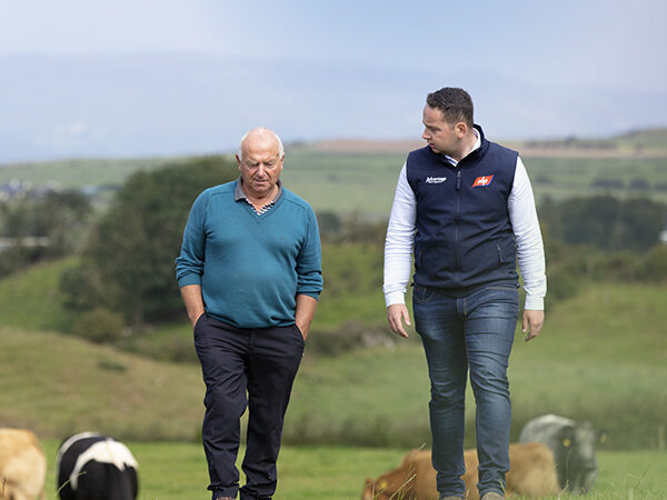 ABP representative walking a field with a farmer