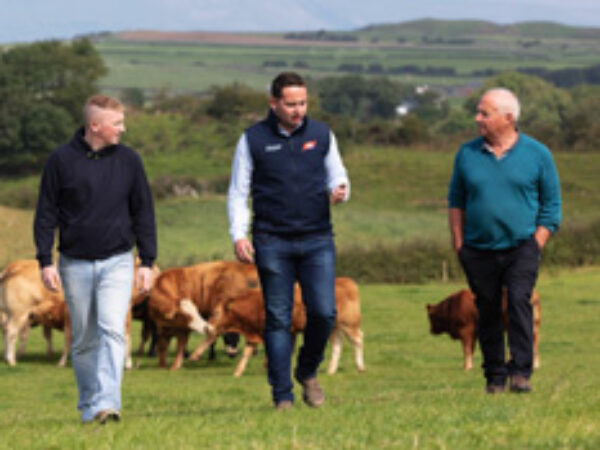 ABP representative and farmers walking across a field