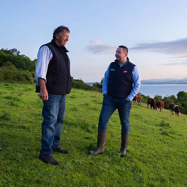 Advantage beef rep and farmer talking in a field