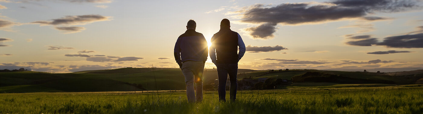 Advantage beef rep and farmer walking across a field